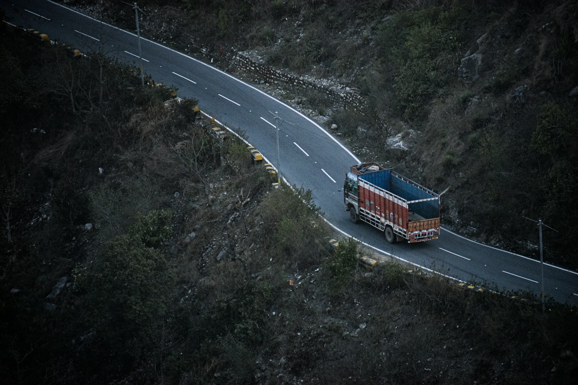 red and blue bus on road during daytime